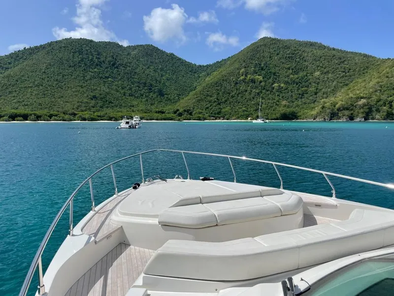 Slide: The Image of Ferretti Yachts 550 (2016) cruising in a serene bay with lush green hills. - 4