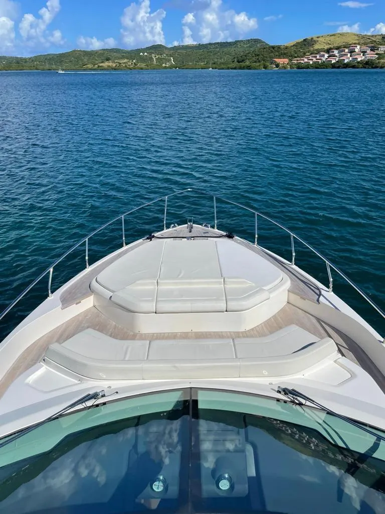 Slide: The Image of 2016 Ferretti Yachts 550 on serene blue waters with scenic background. - 5