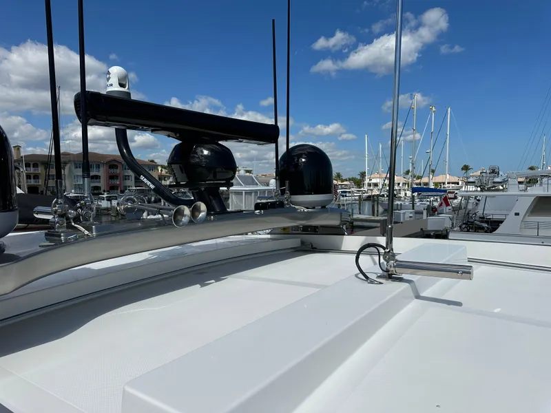 Slide: The Image of 2022 Riviera Sport Yacht 5400 Platinum Edition, docked with clear blue sky and marina background. - 15