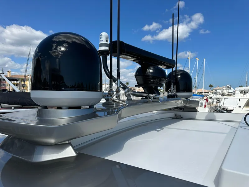 Slide: The Image of Riviera Sport Yacht 5400 Platinum Edition 2022, featuring advanced radar equipment under a clear blue sky. - 16