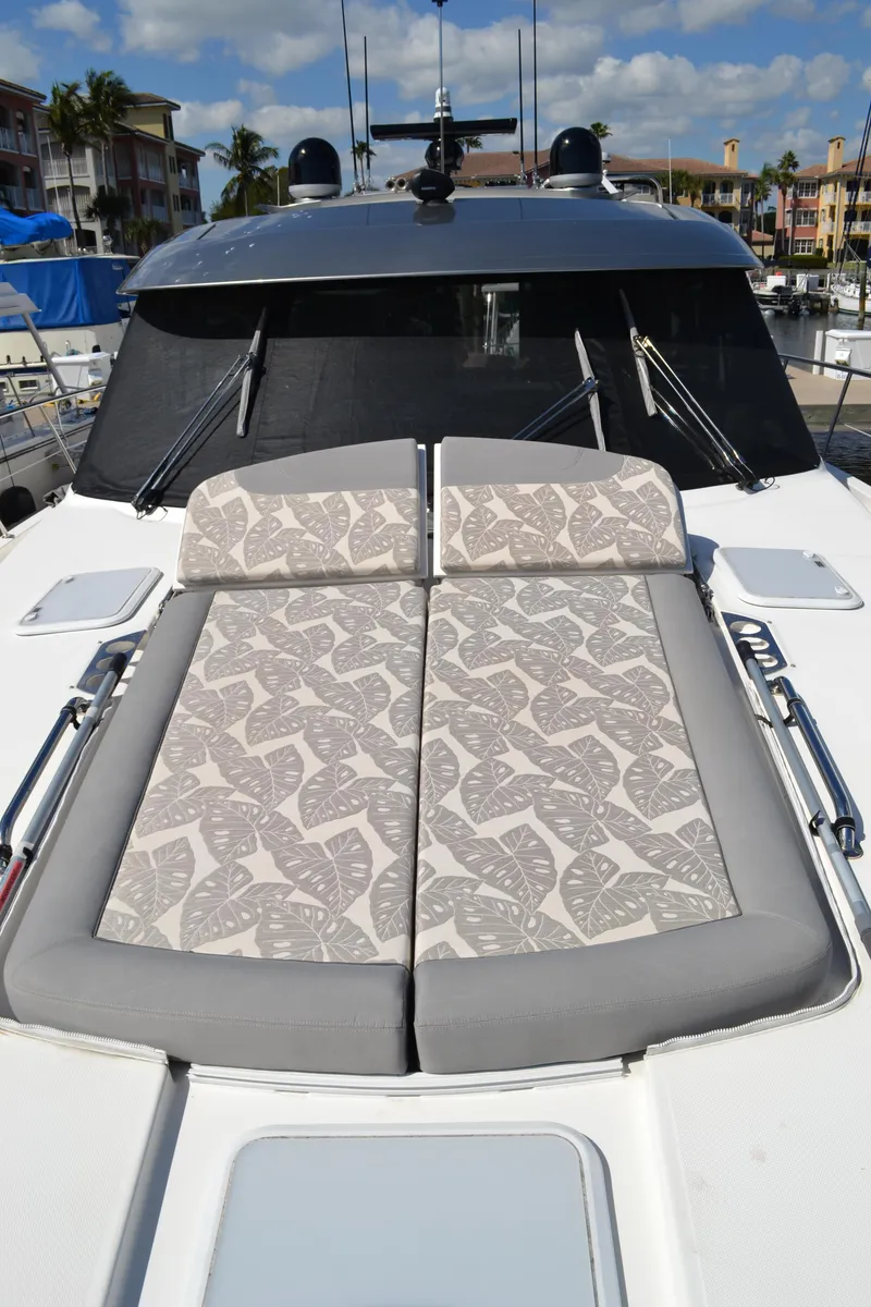 Slide: The Image of 2022 Riviera Sport Yacht 5400 Platinum Edition with sunbathing cushions on deck. - 21