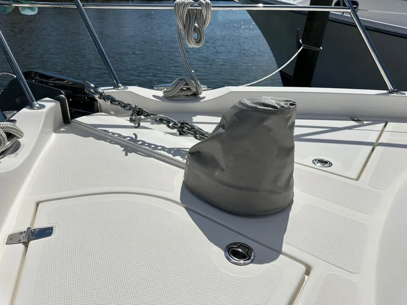 Slide: The Image of 2022 Riviera Sport Yacht 5400 Platinum Edition deck with anchor chain and cover. - 22