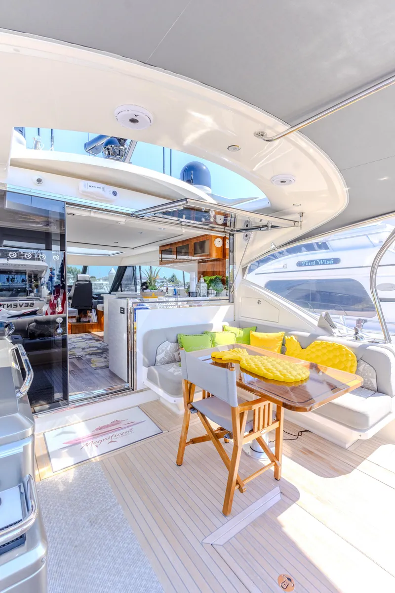 Slide: The Image of 2022 Riviera Sport Yacht 5400 Platinum Edition interior with modern seating and dining area. - 33