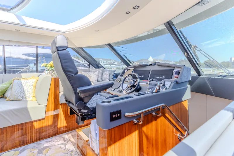 Slide: The Image of Luxurious helm of 2022 Riviera Sport Yacht 5400 Platinum Edition with plush seating and advanced controls. - 48
