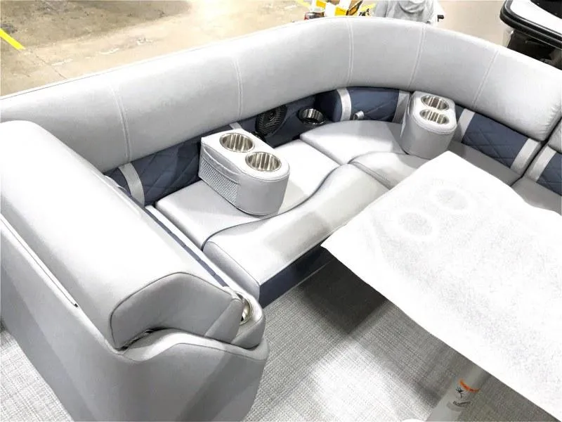 Slide: The Image of 2024 Bennington 24 LSBA boat interior with gray seating and cup holders. - 5