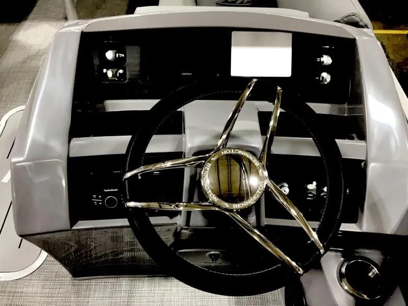 Slide: The Image of 2024 Bennington 24 LSBA boat dashboard with steering wheel and control panel. - 6