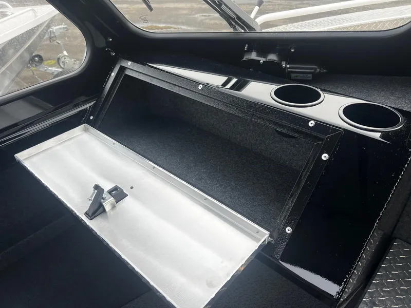 Slide: The Image of 2024 Thunder Jet 21 Chinook OS interior storage compartment with cup holders. - 11