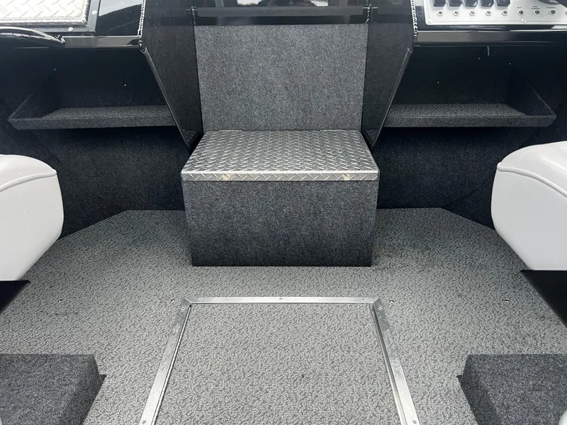 Slide: The Image of 2024 Thunder Jet 21 Chinook OS boat interior with grey carpet and seating. - 12