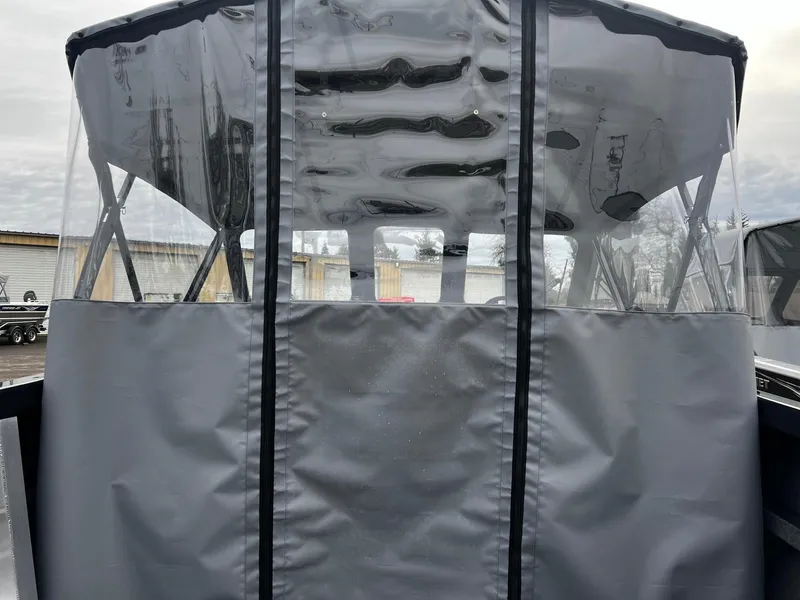 Slide: The Image of 2024 Thunder Jet 21 Chinook OS boat with protective cover and clear windows. - 18