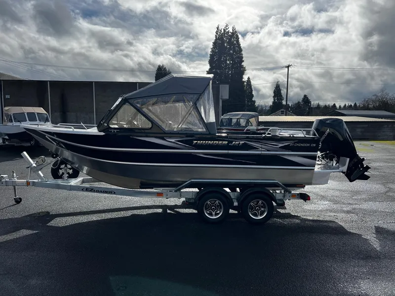 Slide: The Image of 2024 Thunder Jet 21 Chinook OS boat on a trailer under cloudy sky. - 5
