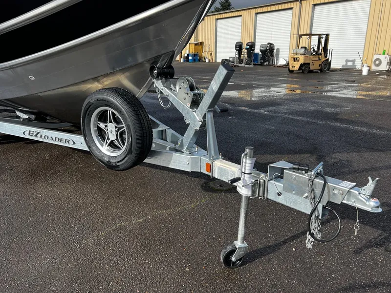 Slide: The Image of 2024 Thunder Jet 21 Chinook OS boat on EZ Loader trailer in industrial lot. - 7