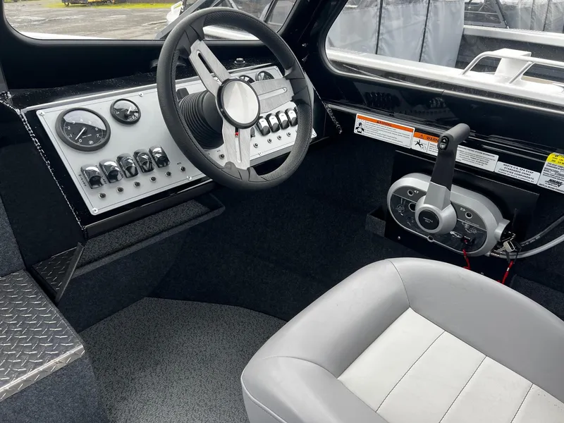 Slide: The Image of 2024 Thunder Jet 21 Chinook OS boat cockpit with steering wheel and control panel. - 9