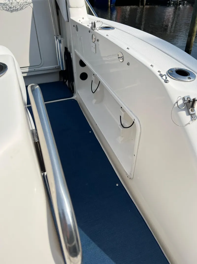 Slide: The Image of 2006 Sea Ray 340 Sundancer boat deck with blue flooring and stainless steel railings. - 11