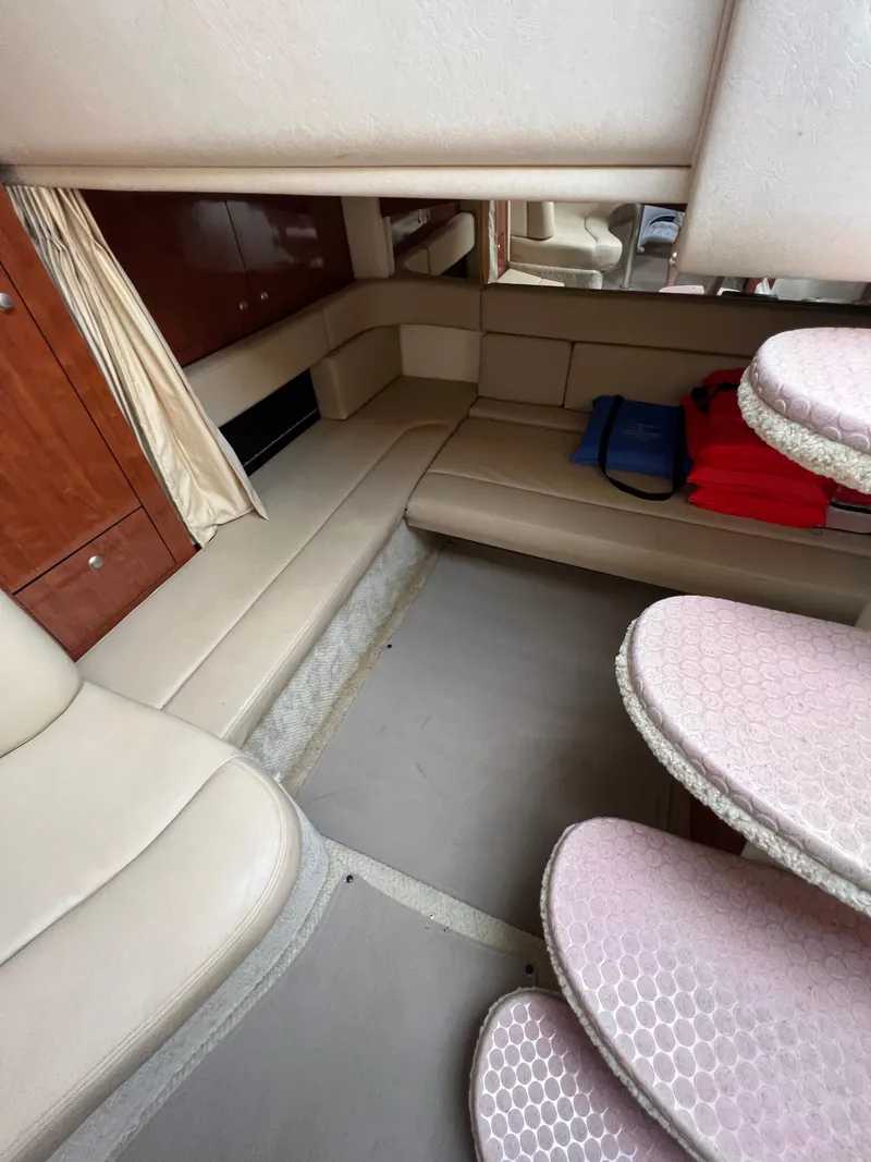 Slide: The Image of Interior of 2006 Sea Ray 340 Sundancer with beige seating and wooden cabinetry. - 13