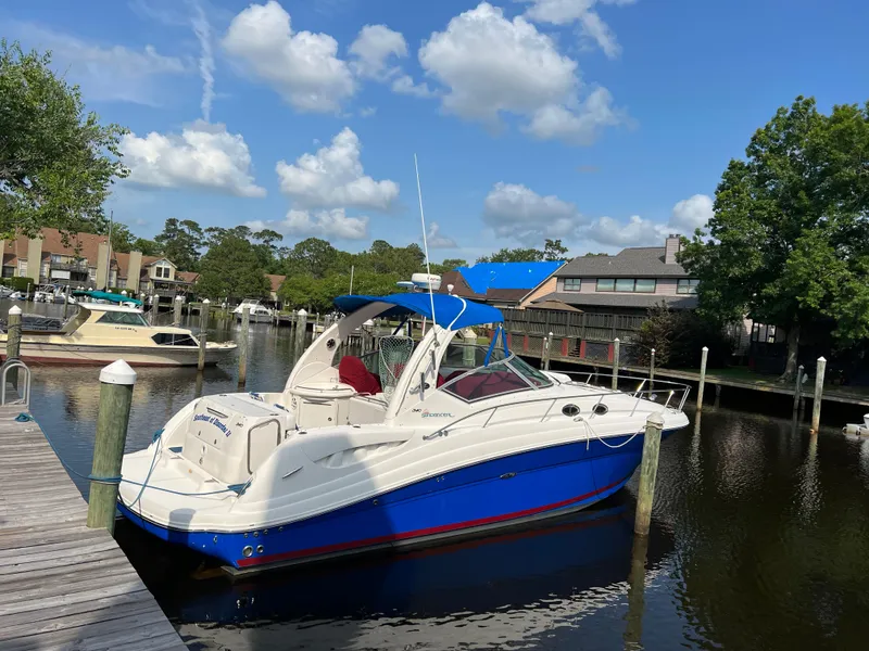 Slide: The Image of 2006 Sea Ray 340 Sundancer docked in a scenic marina under a blue sky. - 3
