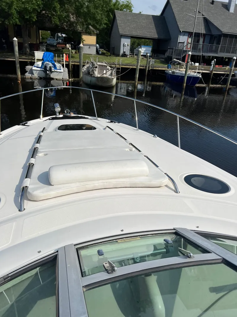 Slide: The Image of 2006 Sea Ray 340 Sundancer docked at a marina, view from the bow. - 6