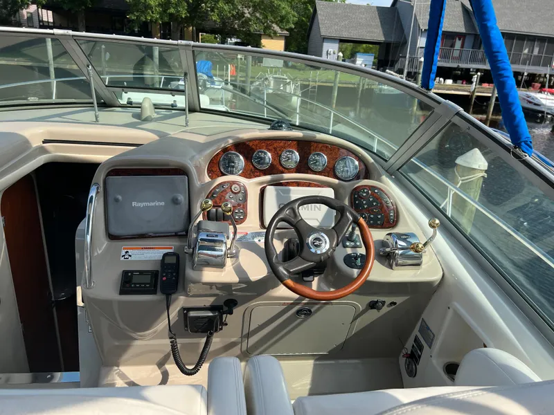Slide: The Image of 2006 Sea Ray 340 Sundancer helm with steering wheel, gauges, and navigation equipment. - 7