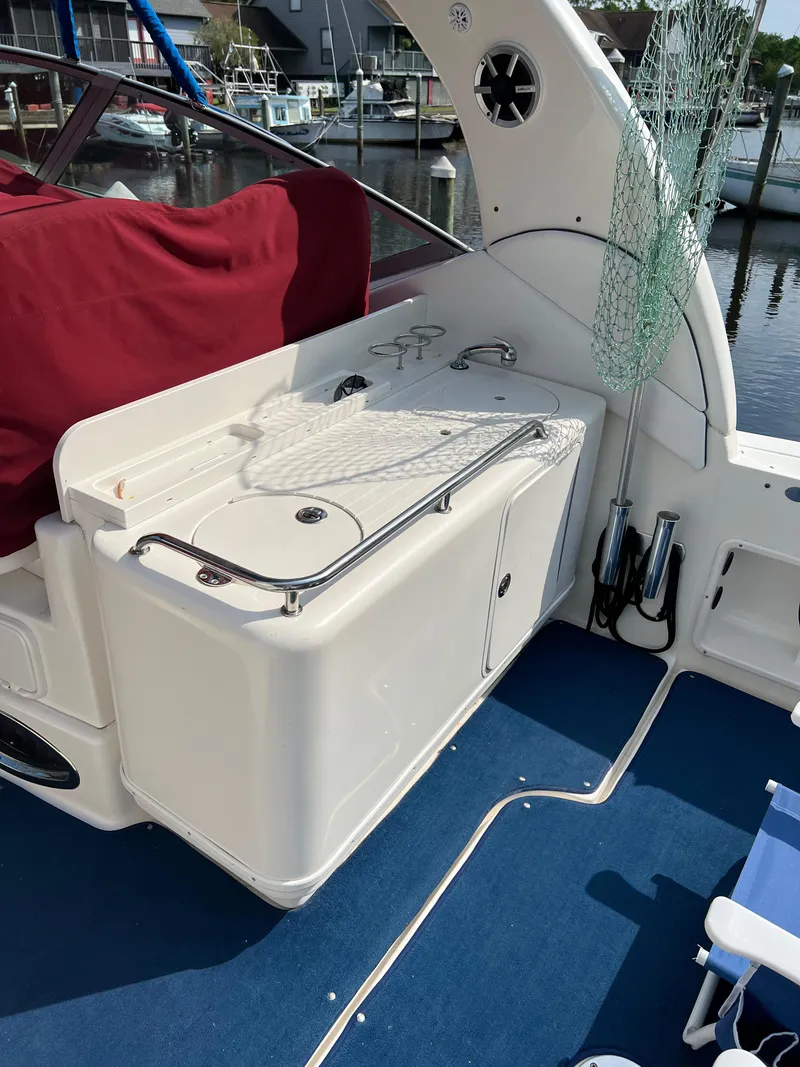 Slide: The Image of 2006 Sea Ray 340 Sundancer boat interior with fishing net and storage area. - 9