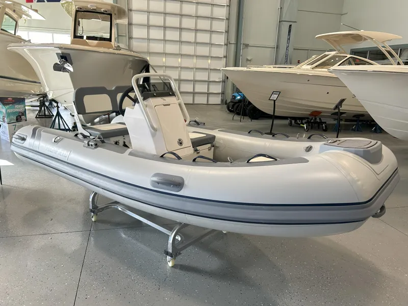 Slide: The Image of 2024 Highfield Classic 360 inflatable boat displayed in a showroom. - 0