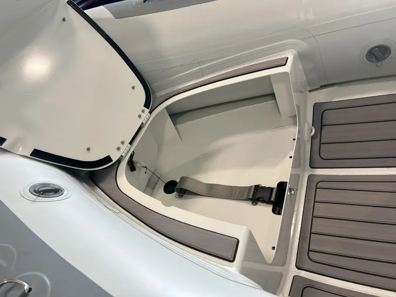 Slide: The Image of 2024 Highfield Classic 360 boat storage compartment with open lid and secure strap. - 5