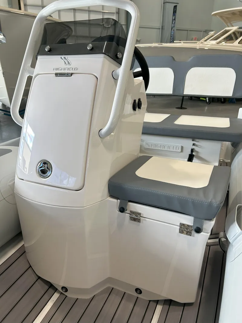 Slide: The Image of 2024 Highfield Classic 360 boat console and seating area. - 6