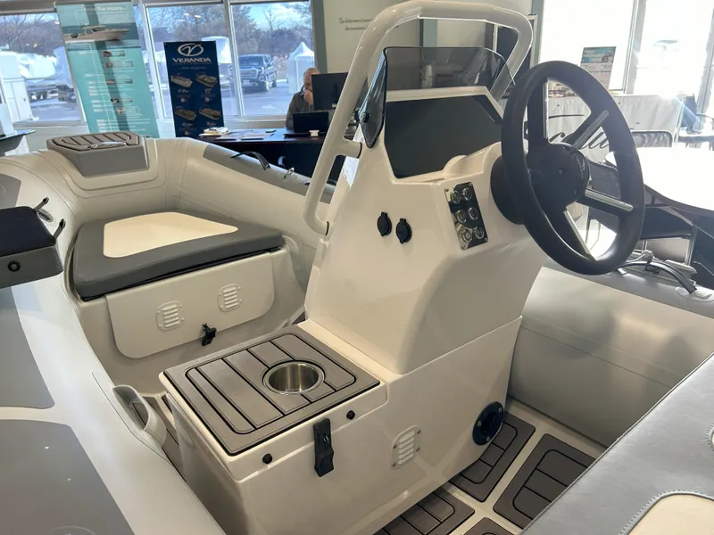 Slide: The Image of 2024 Highfield Classic 360 boat interior with steering console and seating. - 7