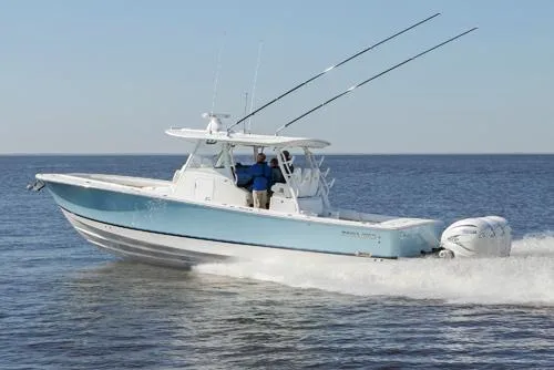 The Image of 2024 Regulator 37 boat on trailer, parked outdoors with palm trees in background. - 0