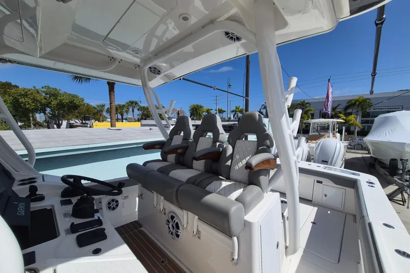 Slide: The Image of 2024 Regulator 37 boat interior with luxury seating and modern helm controls. - 13