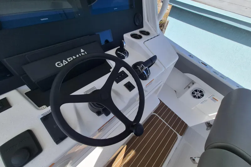 Slide: The Image of 2024 Regulator 37 boat helm with Garmin electronics and modern controls. - 14