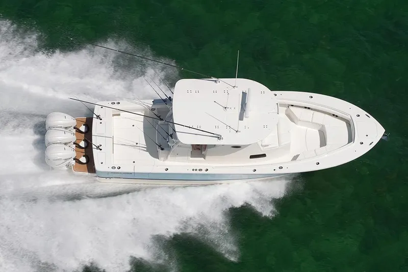 Slide: The Image of 2024 Regulator 37 boat on trailer under clear blue sky. - 2