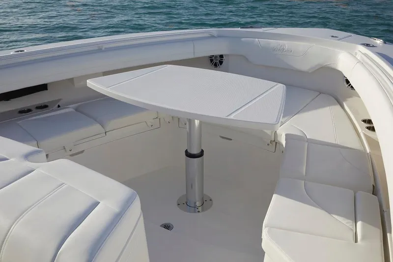 Slide: The Image of 2024 Regulator 37 boat on trailer with Yamaha engines, parked near palm trees. - 4