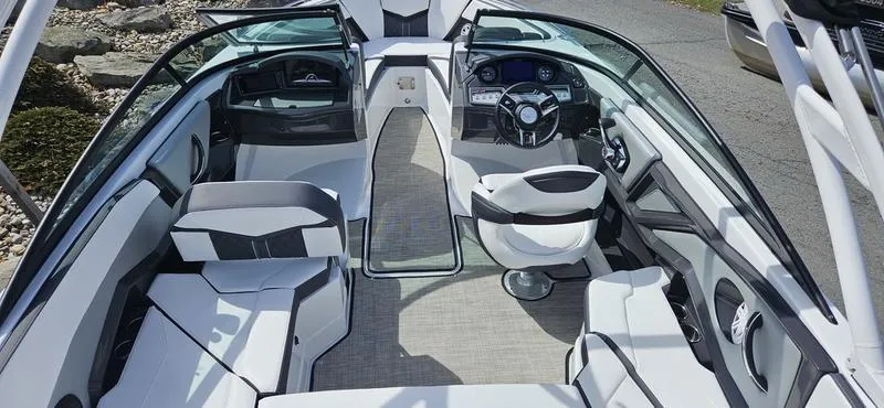 Slide: The Image of 2024 Monterey 238 Super Sport boat interior with modern seating and steering console. - 2