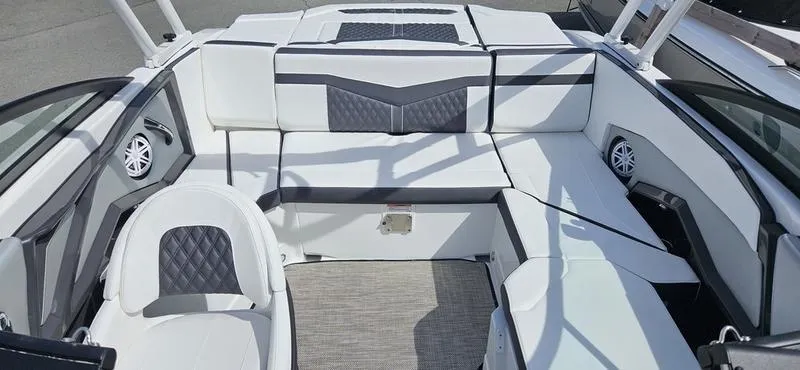 Slide: The Image of 2024 Monterey 238 Super Sport boat interior with white and gray seating. - 3