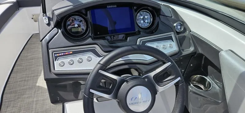 Slide: The Image of 2024 Monterey 238 Super Sport boat dashboard with steering wheel and control panel. - 5
