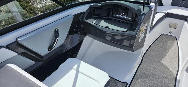 Slide: The Image of 2024 Monterey 238 Super Sport boat interior with modern dashboard and seating. - 7