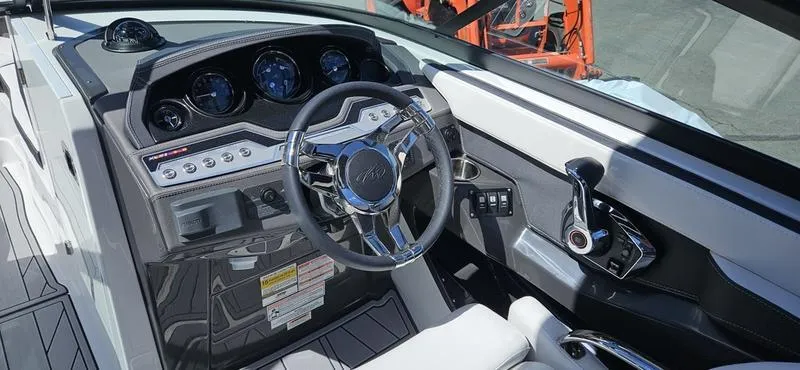 Slide: The Image of 2024 Monterey 258 boat cockpit with steering wheel and control panel. - 12