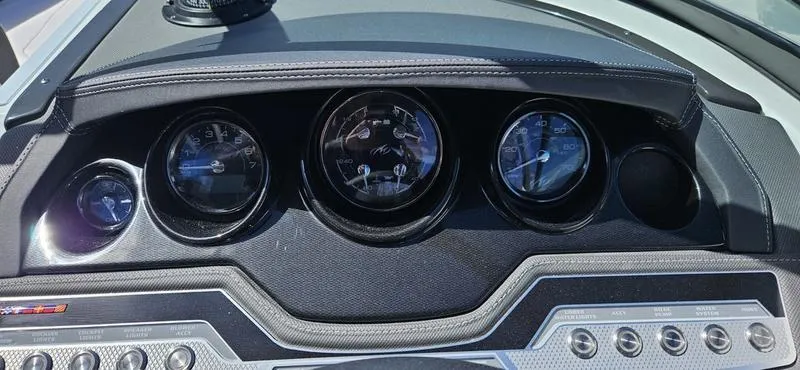 Slide: The Image of 2024 Monterey 258 boat dashboard with gauges and controls. - 2