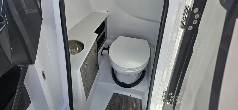 Slide: The Image of 2024 Monterey 258 boat interior bathroom with toilet and sink. - 3
