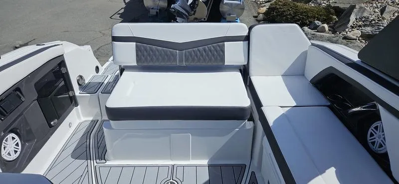 Slide: The Image of 2024 Monterey 258 boat interior with white and gray seating. - 9
