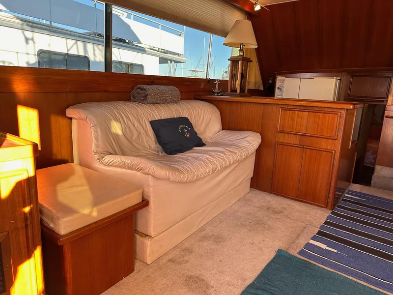 Slide: The Image of Interior of 1987 Post 46 SPORT yacht with cozy seating and wooden cabinetry. - 11