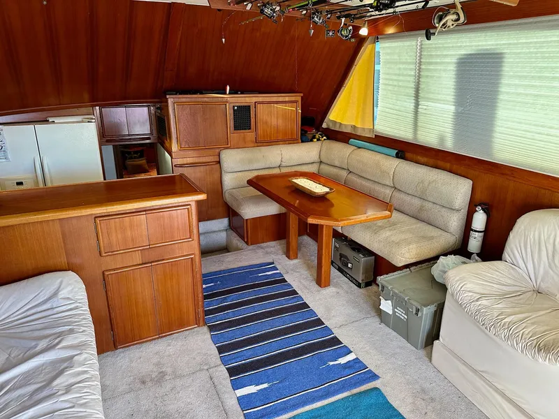 Slide: The Image of Interior of 1987 Post 46 SPORT yacht with wooden cabinetry and cozy seating area. - 12