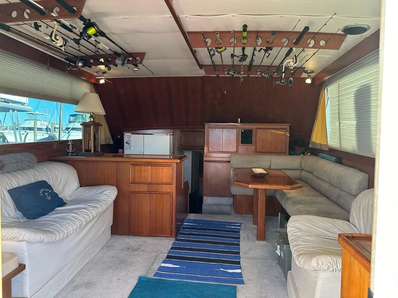 Slide: The Image of Interior of 1987 Post 46 SPORT yacht with fishing rods and cozy seating area. - 14