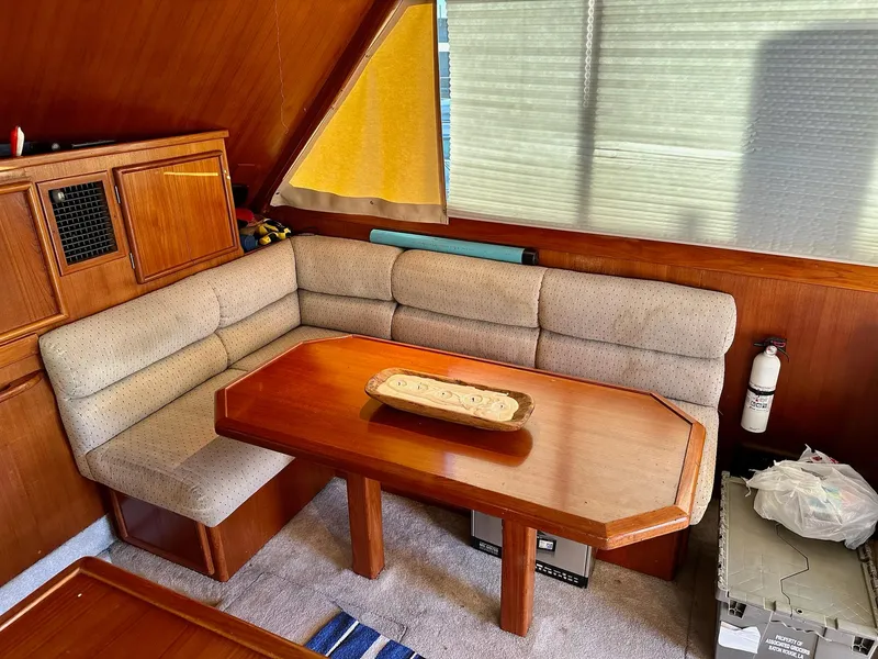 Slide: The Image of Cozy interior of 1987 Post 46 SPORT yacht with wooden table and cushioned seating. - 18