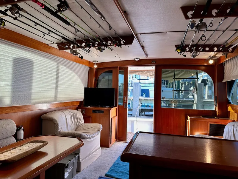 Slide: The Image of Interior of 1987 Post 46 SPORT yacht with fishing rods, seating, and TV. - 19