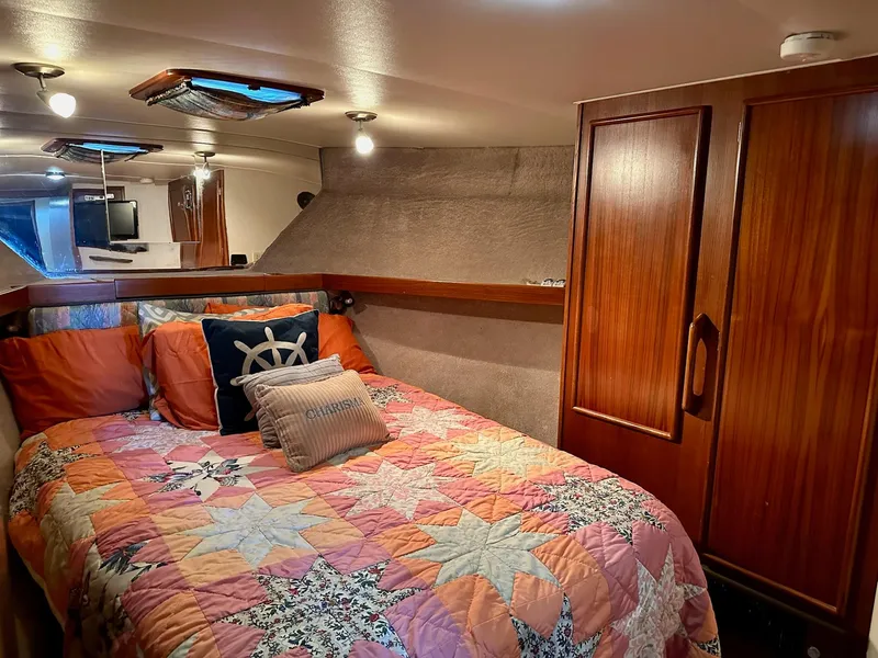 Slide: The Image of Cozy cabin interior of 1987 Post 46 SPORT yacht with colorful bedding and wooden cabinetry. - 21