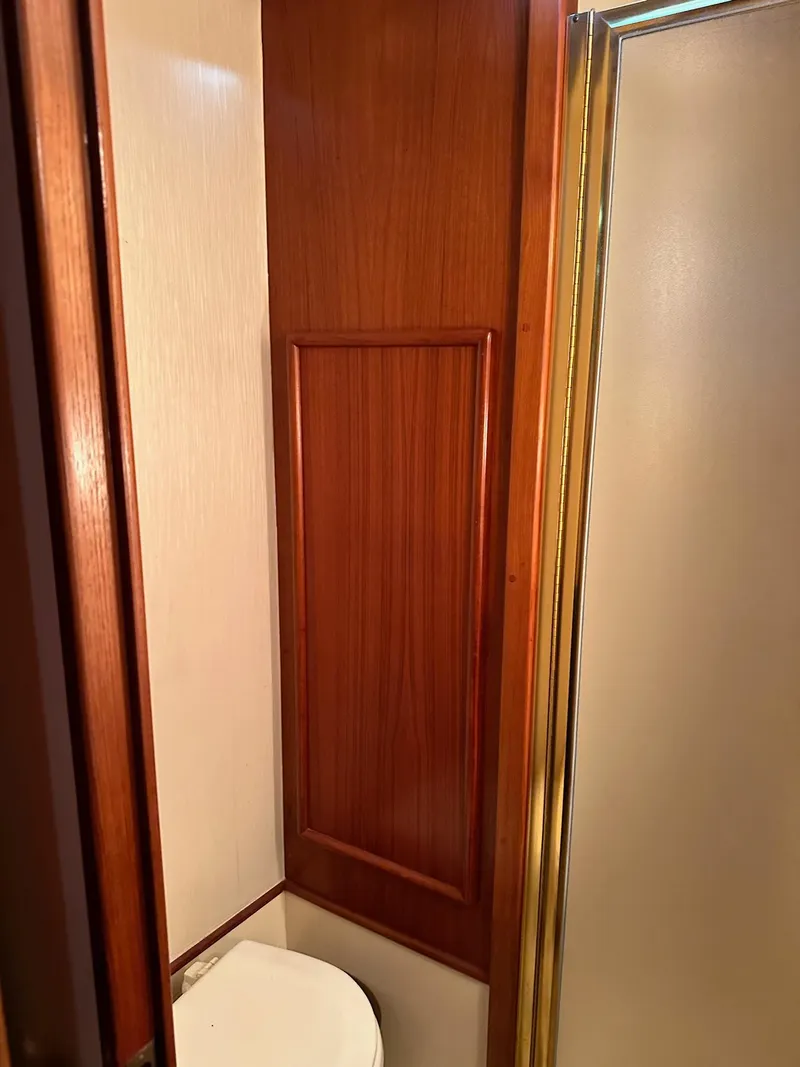 Slide: The Image of 1987 Post 46 SPORT yacht bathroom with wooden paneling and shower. - 25