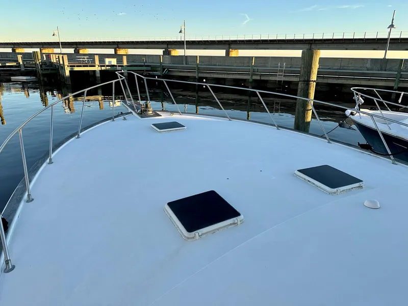 Slide: The Image of 1987 Post 46 SPORT yacht deck at marina, calm water, clear sky. - 3