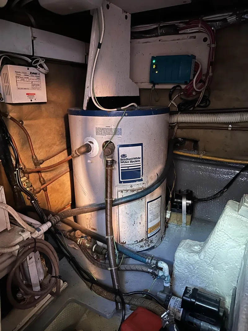 Slide: The Image of Engine room of a 1987 Post 46 SPORT boat with water heater and electrical components. - 32