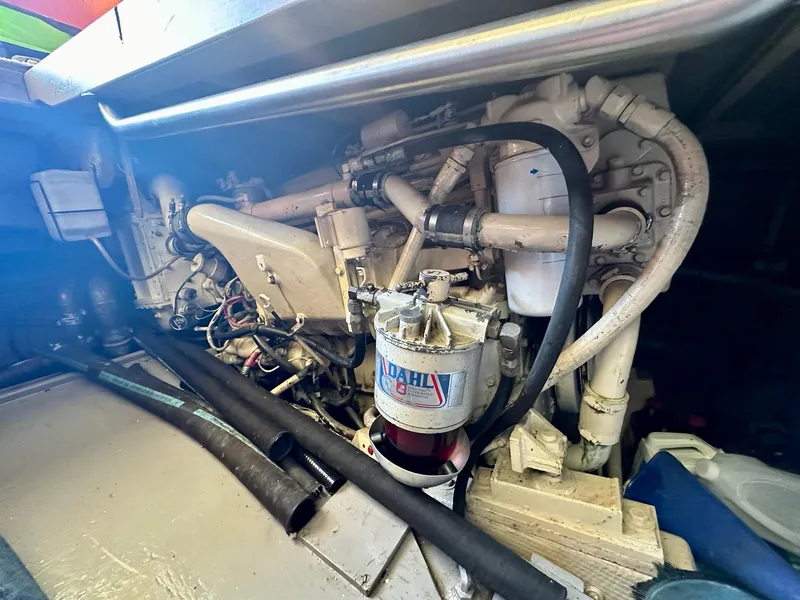 Slide: The Image of Engine compartment of a 1987 Post 46 SPORT boat, featuring mechanical components and hoses. - 33