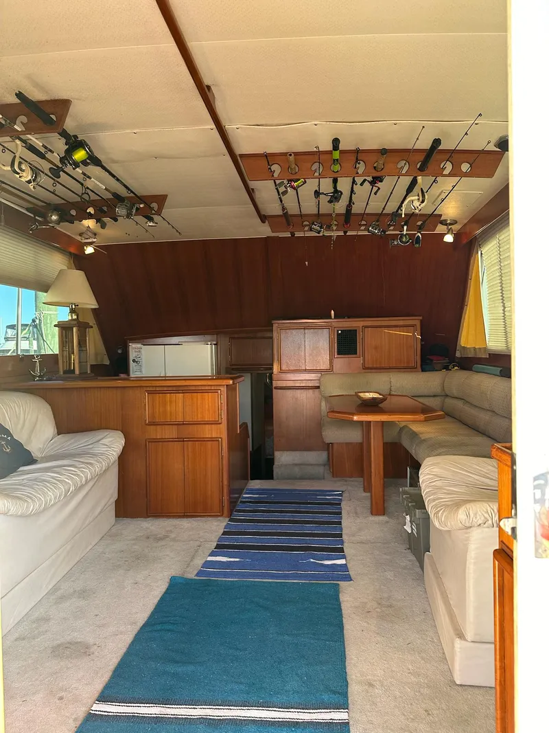 Slide: The Image of Interior of 1987 Post 46 SPORT yacht with fishing rods and cozy seating area. - 13